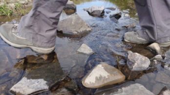 walking boots on stepping stones
